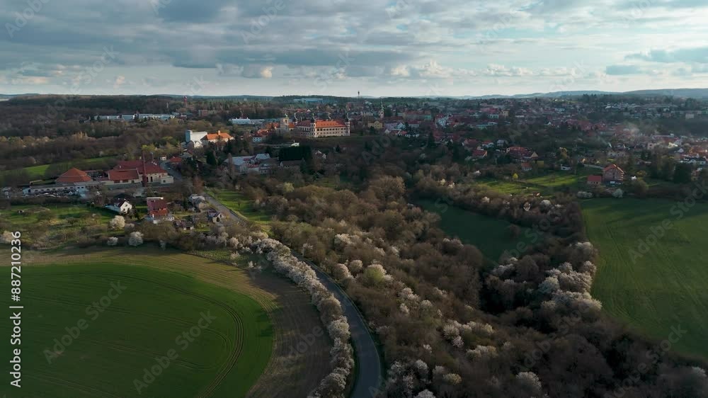 Flying towards the bohemian town Kostelec nad Černými lesy with fields and blooming trees in front Flying towards the bohemian town Kostelec nad Černými lesy with fields and blooming trees in front