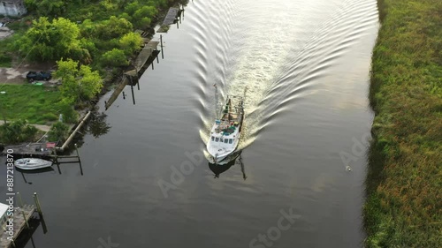 Aerial View Around Boat Sailing Down Scipio Creek in Apalachicola Florida photo