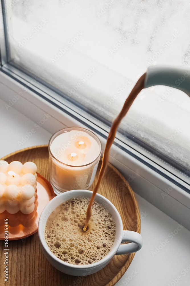 Cozy coffee and candles by a frosty window Cozy coffee and candles by a frosty window