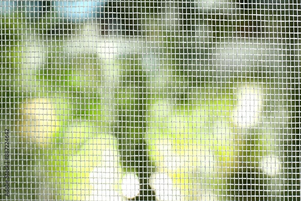 Insect screen for window against blurred background, closeup Insect screen for window against blurred background, closeup
