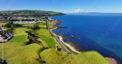 Aerial View of Red Bay Castle Cushendall Waterfoot on the Irish Sea Antrim Northern Ireland on a sunny day with a blue sky photo