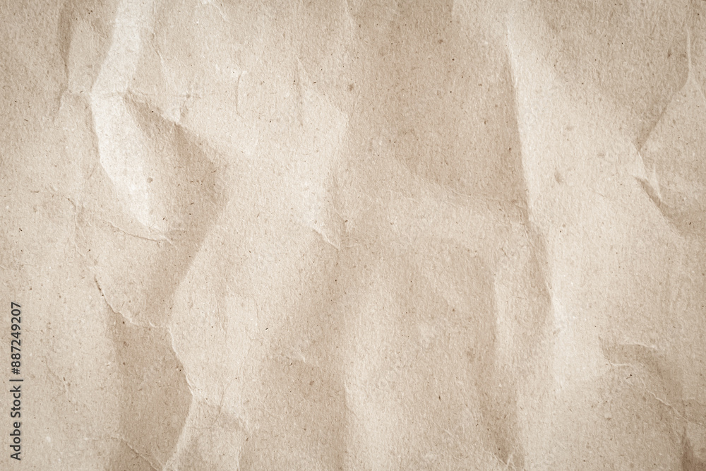 Naklejka premium Crumpled brown paper texture background for design with copy space for text or image.
