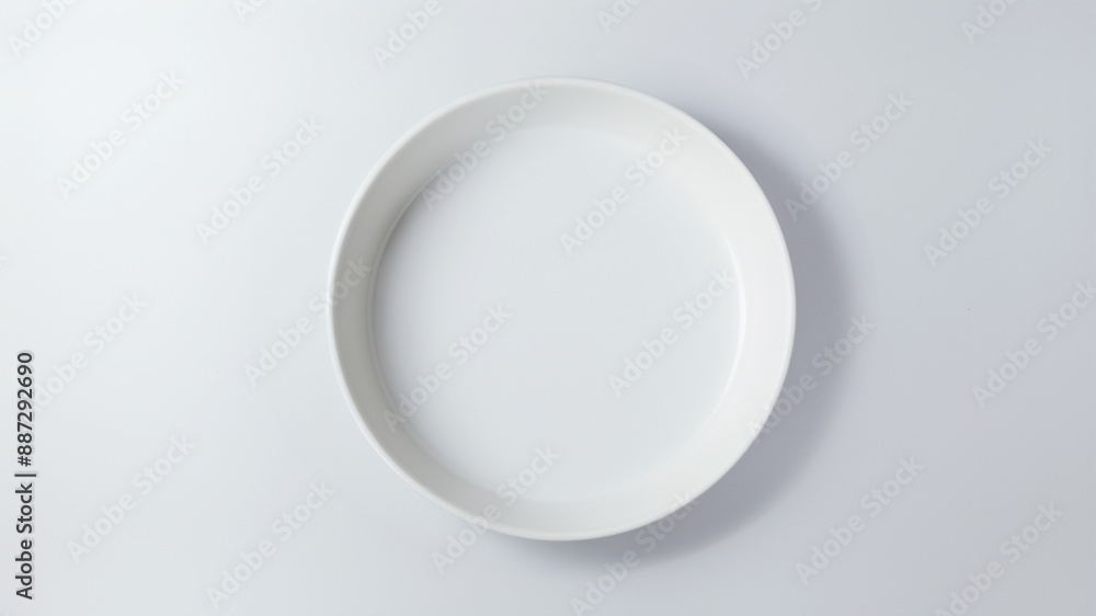 Empty white ceramic plate, minimalist food presentation on white background Empty white ceramic plate, minimalist food presentation on white background