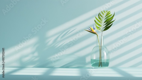 A quirky glass vase with a bird of paradise flower in a tropical conservatory.