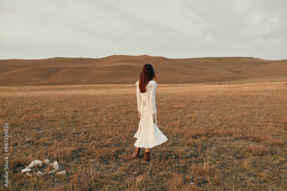 Woman standing in white dress in open field on sunny day, beauty of nature and fashion in harmony Woman standing in white dress in open field on sunny day, beauty of nature and fashion in harmony