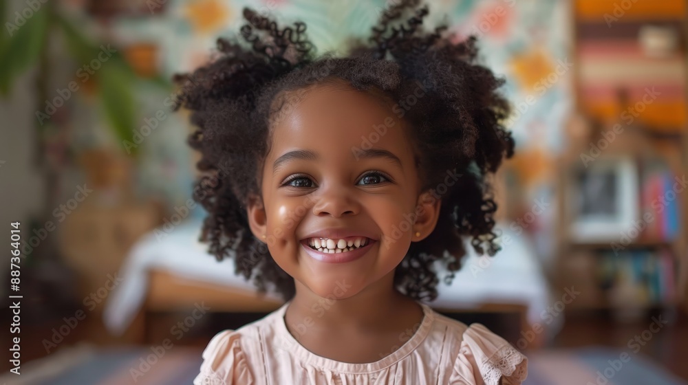Joyful Child with Curly Hair Smiling Indoors in a Colorful Room with Natural Light Joyful Child with Curly Hair Smiling Indoors in a Colorful Room with Natural Light