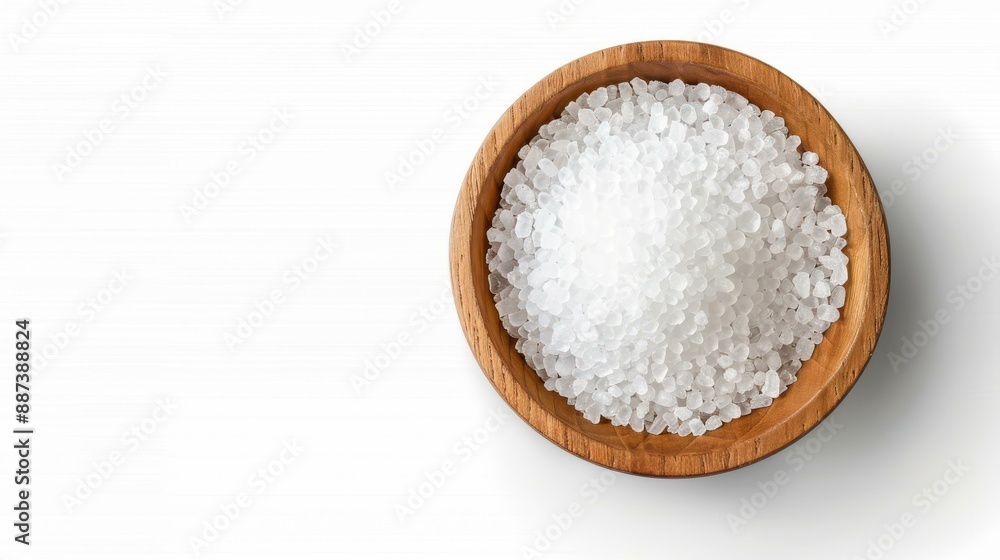 Top view of sea salt in a rustic wooden bowl on white background. Simple and elegant food styling. Top view of sea salt in a rustic wooden bowl on white background. Simple and elegant food styling.
