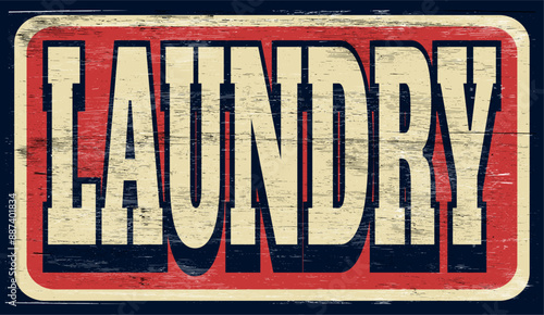 Aged and worn laundry sign on wood