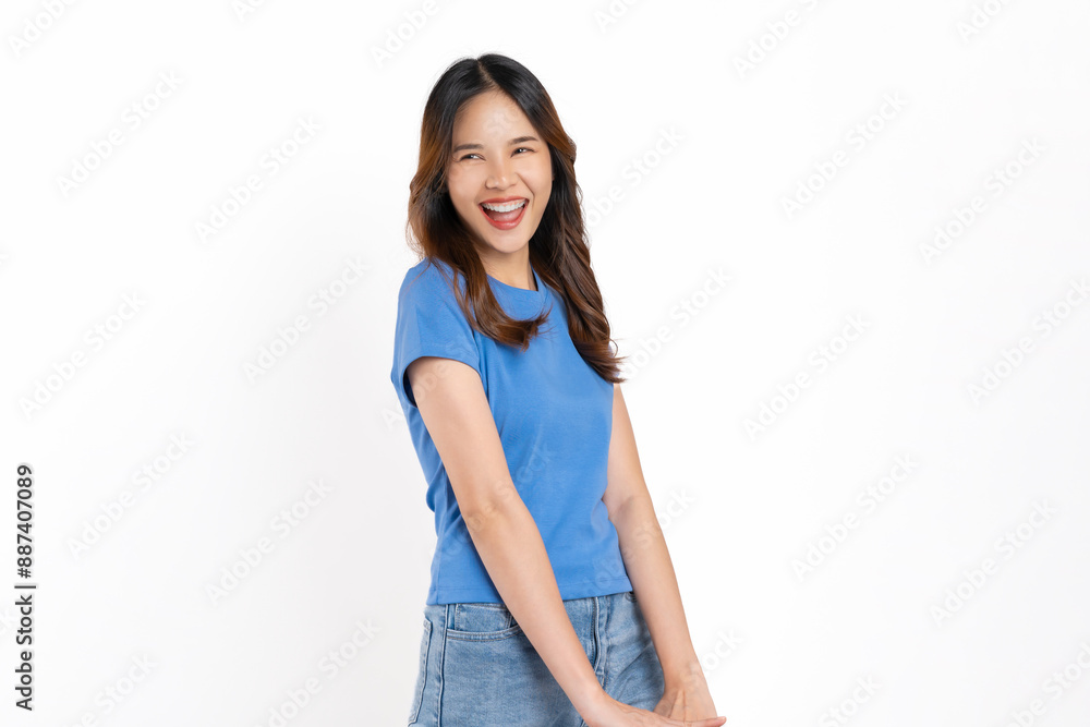 Happy cheerful young woman wearing casual blue t-shirt with standing and posing on white background. Happy cheerful young woman wearing casual blue t-shirt with standing and posing on white background.