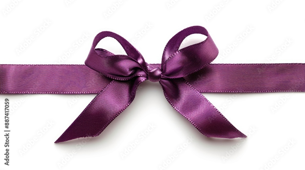 A solitary purple bow tied with criss crossed ribbons set against a white background A solitary purple bow tied with criss crossed ribbons set against a white background