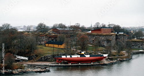 View of red boat lying in Fortress of Suomenlinna in Helsinki, Finland photo