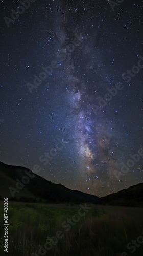 Milky Way visible above lush green hills at night