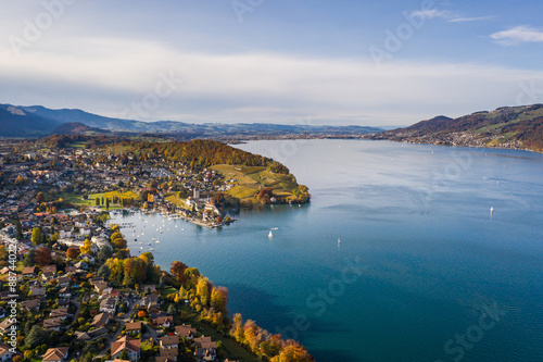 Obraz na płótnie Spiez, Bern: Stunning aerial drone view of lake Thun and the Spiez village with its famous medieval castle and old town in the alps in Canton Bern in Switzerland w salonie