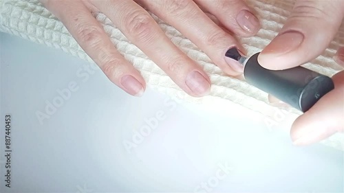 Gel polish manicure step-by-step video tutorial. Step 7 Nails base coat. Applying a base coat rubbing into the surface of the nail for better adhesion photo