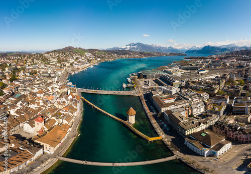 Lucerne, Switzerland: Aerial drone view of the Reuss river in Lucerne old town with the famous Chapel wooden bridge before reaching lake Lucerne in Switzerland.