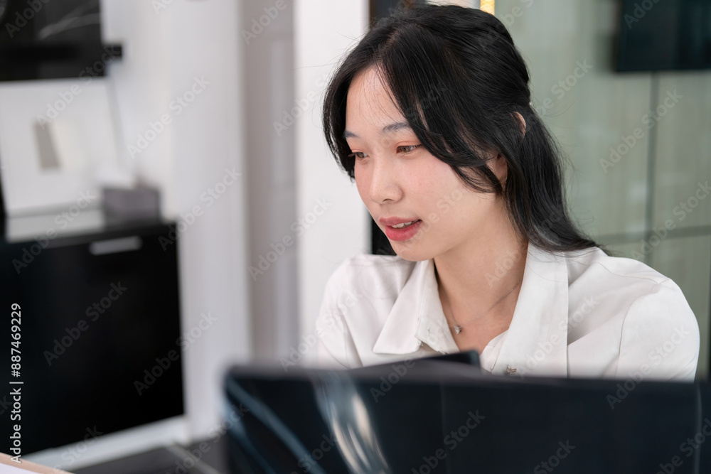 Young woman calculates stock value using calculator Young woman calculates stock value using calculator