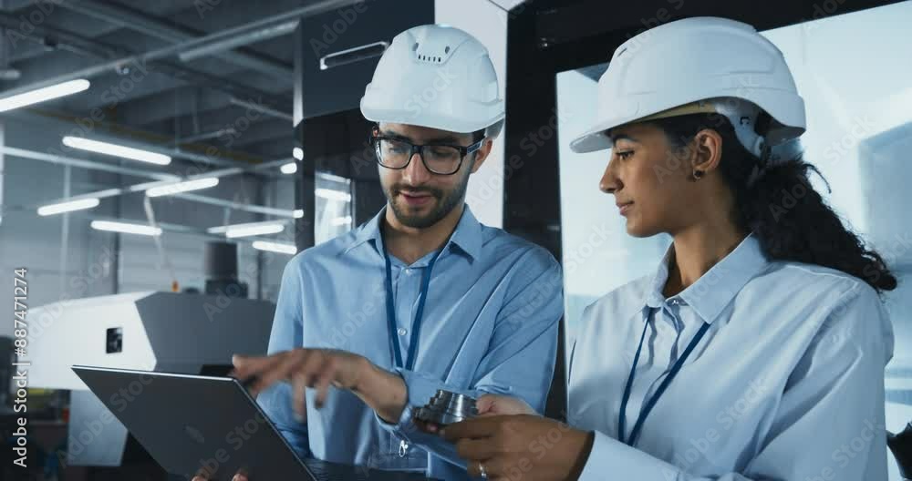 Manufacturing Process Manager and Equipment Supervisor Having a Meeting on Factory Floor. Looking at a Metal part, Discussing Production Technology, Component Delivery Techniques and Dimensions Manufacturing Process Manager and Equipment Supervisor Having a Meeting on Factory Floor. Looking at a Metal part, Discussing Production Technology, Component Delivery Techniques and Dimensions