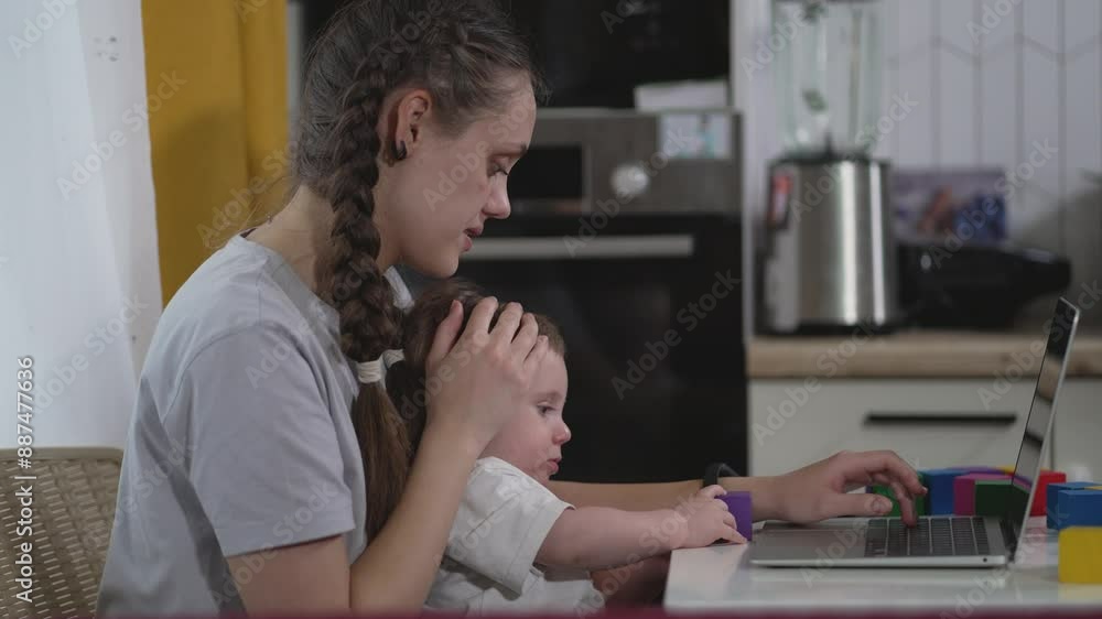 Mom and baby work together at home. Caring mom guides child on laptop. Family together mom works child learns. Home office harmony with mom and child. Mother and child bonding over work at home. Mom and baby work together at home. Caring mom guides child on laptop. Family together mom works child learns. Home office harmony with mom and child. Mother and child bonding over work at home.