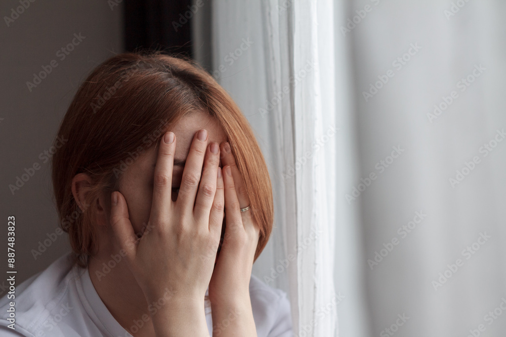 Portrait of a depressed woman: pale face, downcast eyes, expression of sadness and fatigue, shadows under the eyes, disheveled hair, blurred and dark Portrait of a depressed woman: pale face, downcast eyes, expression of sadness and fatigue, shadows under the eyes, disheveled hair, blurred and dark