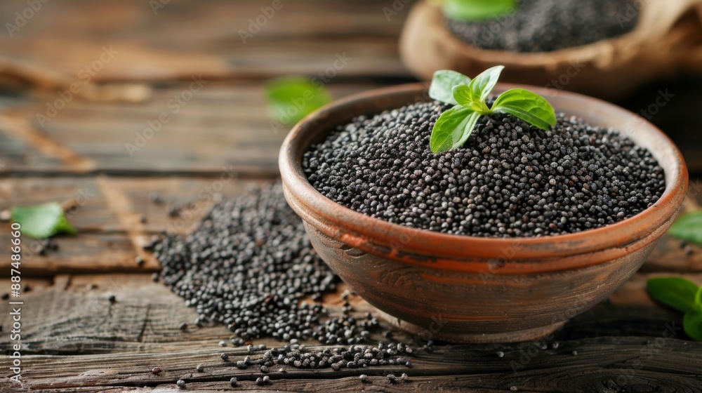 Poppy seeds in small wooden bowl on dark table. Poppies head on board with backlight. Poppy seeds in small wooden bowl on dark table. Poppies head on board with backlight.