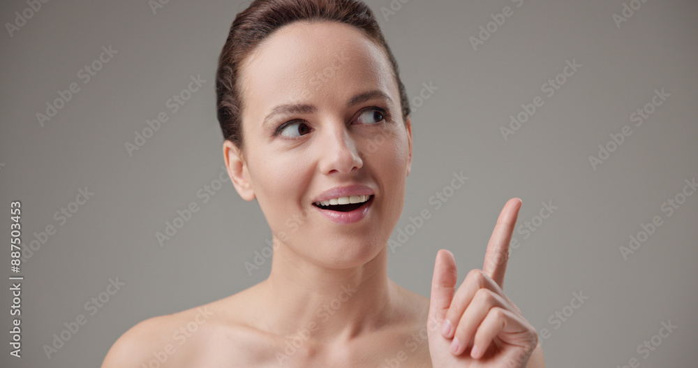 Beauty, health, cosmetics, anti-aging therapy and skin care concept - young beautiful brunette Caucasian woman raising finger and showing idea gesture Beauty, health, cosmetics, anti-aging therapy and skin care concept - young beautiful brunette Caucasian woman raising finger and showing idea gesture