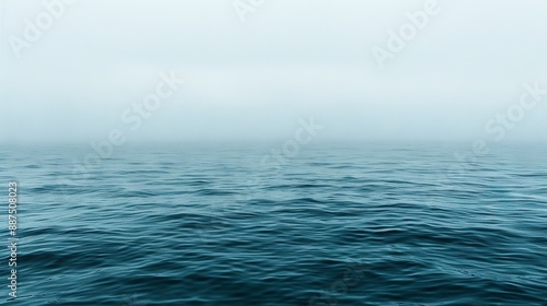   Large water body with misty sky and distant waves