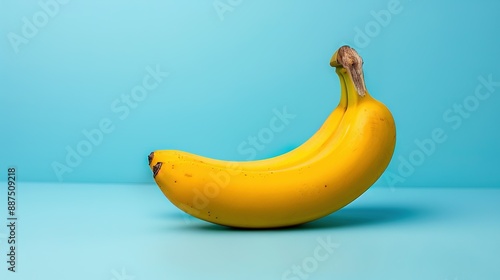  Banana with bird on blue surface in front of blue background