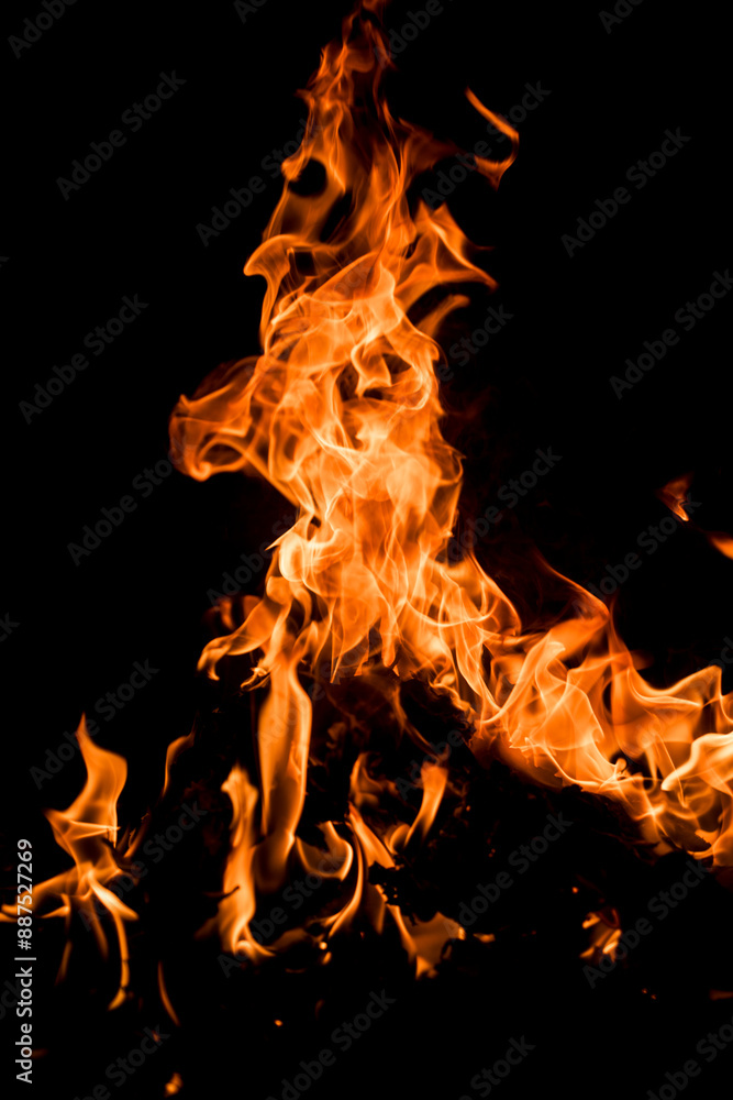 Fototapeta premium Fire over black background. Fire sparks background. Abstract blaze flames background. Burning fire. Texture of fire on a black background.