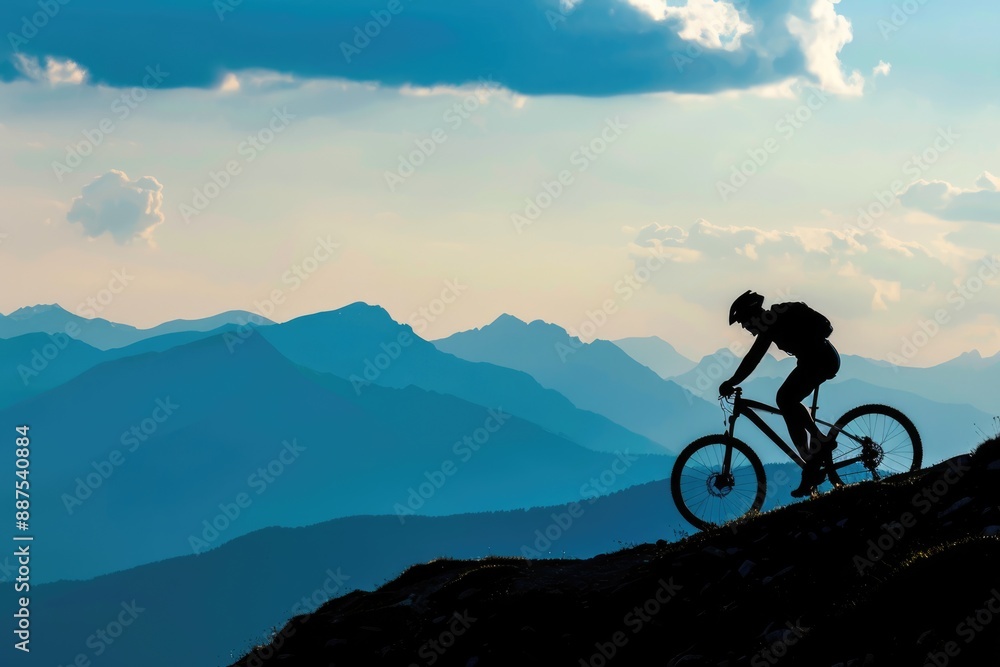 Silhouette cyclist riding on mountain against sky Silhouette cyclist riding on mountain against sky