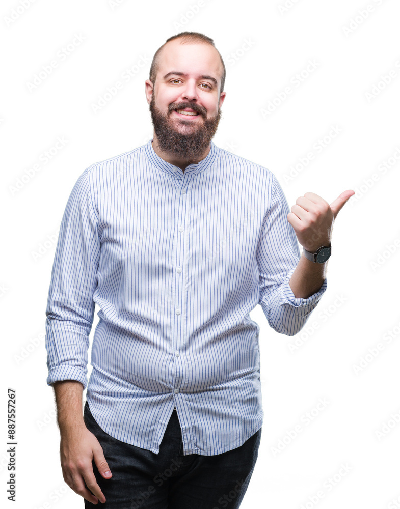 Young caucasian hipster man over isolated background smiling with happy face looking and pointing to the side with thumb up. Young caucasian hipster man over isolated background smiling with happy face looking and pointing to the side with thumb up.