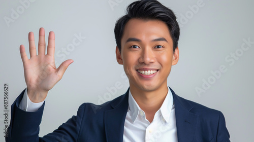 A youthful businessman confidently displaying five fingers to the camera. photo