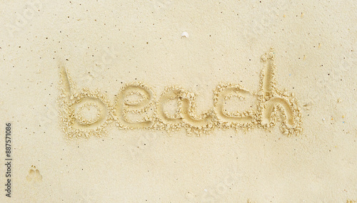 Writing in light yellowish sea sand of the word beach. Tropical island on clean sand with free areas for text. Photographed from above in close-up. Suitable for vacation postcards