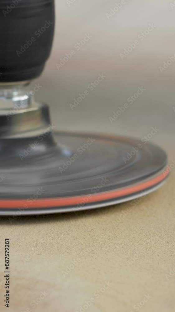 The sander is applied to a piece of wood, its abrasive action steadily removing imperfections and creating a smooth texture. Power tool used to smooth surfaces by abrasion with sandpaper The sander is applied to a piece of wood, its abrasive action steadily removing imperfections and creating a smooth texture. Power tool used to smooth surfaces by abrasion with sandpaper