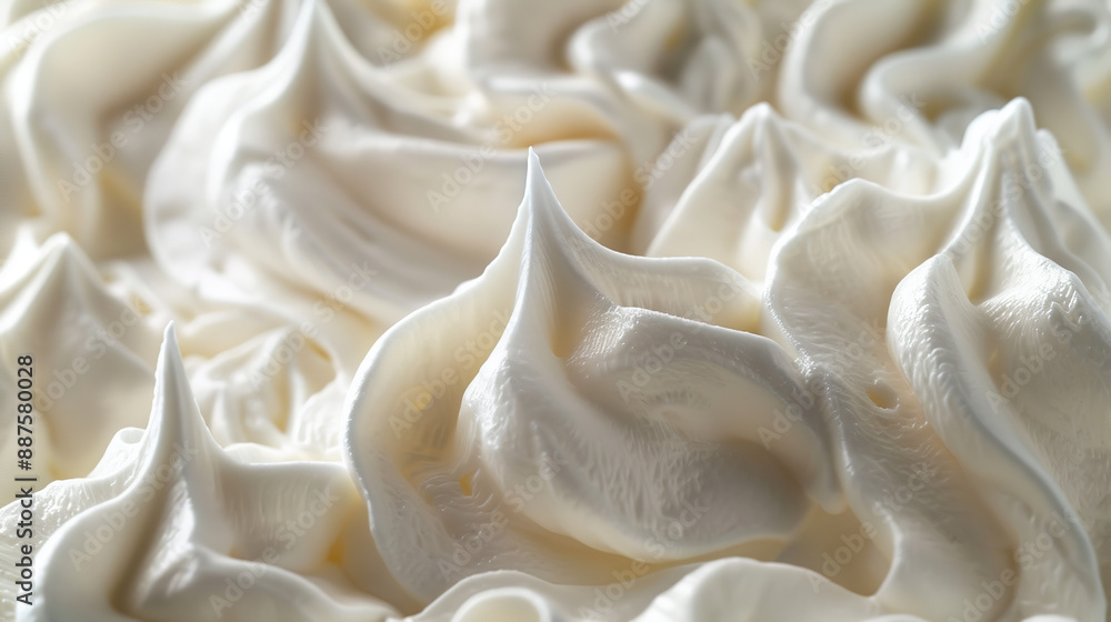 A close-up of white whipped cream showcases a smooth, airy swirl, creating a soft and inviting texture A close-up of white whipped cream showcases a smooth, airy swirl, creating a soft and inviting texture
