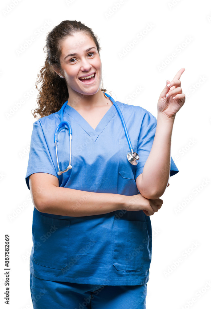 Young brunette doctor girl wearing nurse or surgeon uniform over isolated background with a big smile on face, pointing with hand and finger to the side looking at the camera. Young brunette doctor girl wearing nurse or surgeon uniform over isolated background with a big smile on face, pointing with hand and finger to the side looking at the camera.