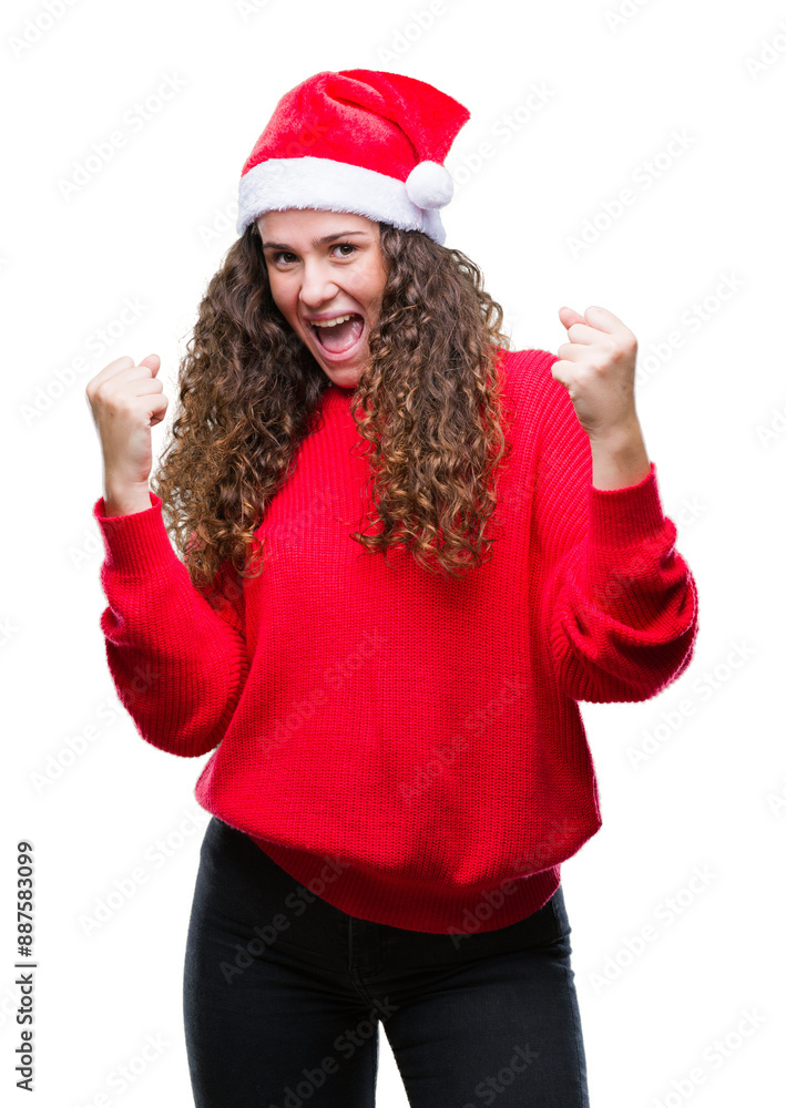 Young brunette girl wearing christmas hat over isolated background very happy and excited doing winner gesture with arms raised, smiling and screaming for success. Celebration concept. Young brunette girl wearing christmas hat over isolated background very happy and excited doing winner gesture with arms raised, smiling and screaming for success. Celebration concept.