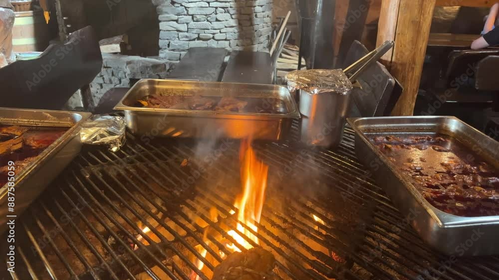 Meat is fried in a restaurant over an open fire. Meat is fried in a restaurant over an open fire.