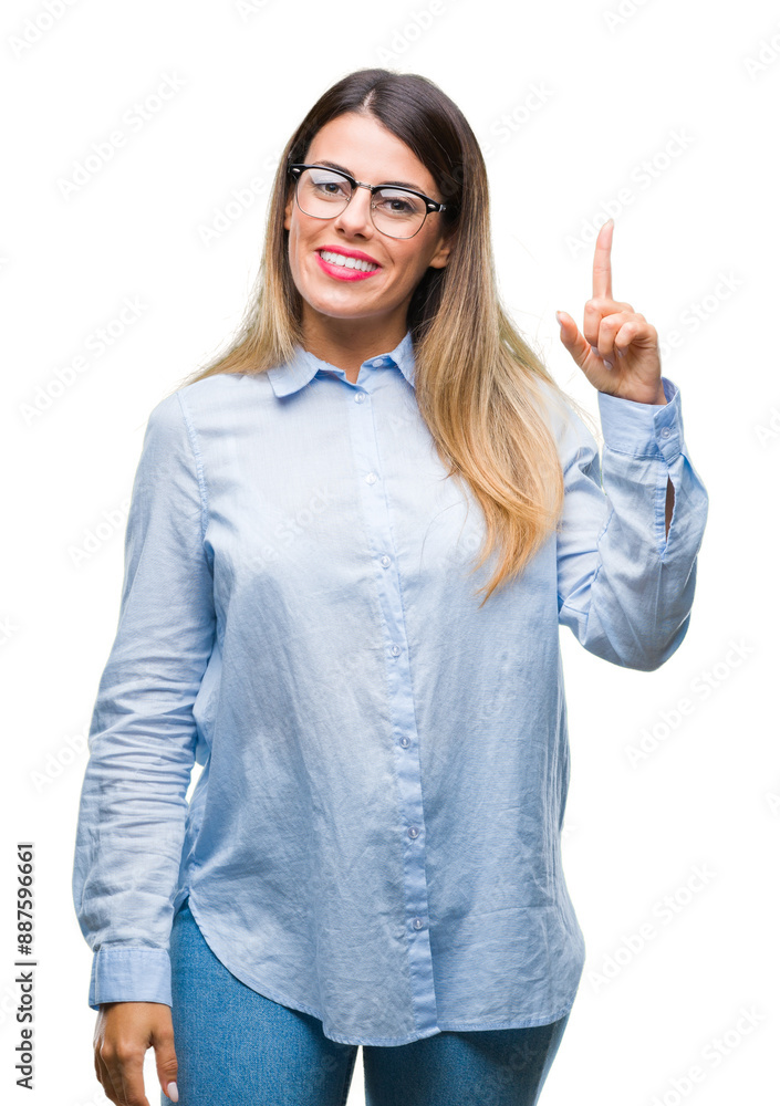 Young beautiful business woman wearing glasses over isolated background pointing finger up with successful idea. Exited and happy. Number one. Young beautiful business woman wearing glasses over isolated background pointing finger up with successful idea. Exited and happy. Number one.