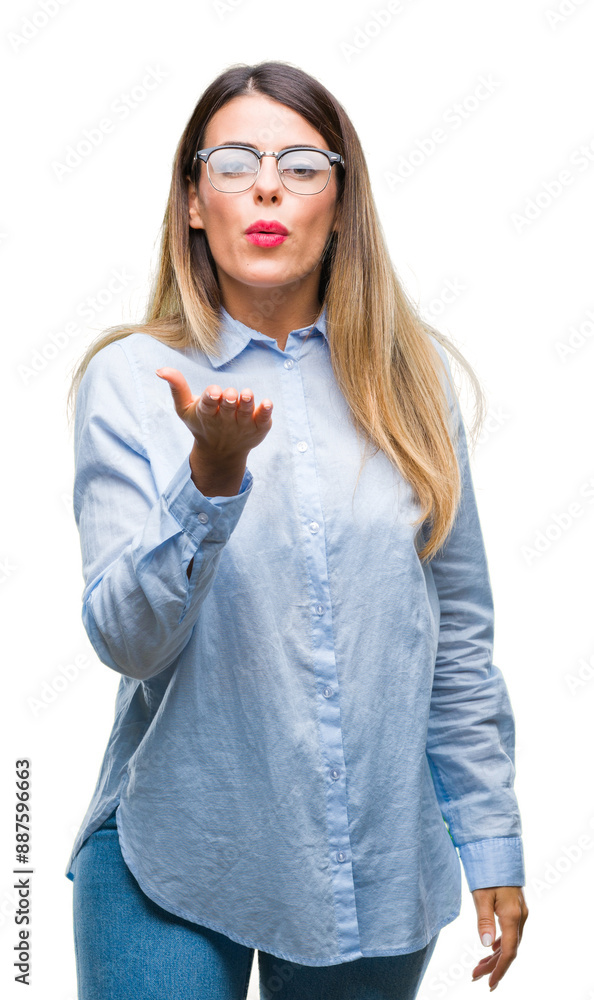 Young beautiful business woman wearing glasses over isolated background looking at the camera blowing a kiss with hand on air being lovely and sexy. Love expression. Young beautiful business woman wearing glasses over isolated background looking at the camera blowing a kiss with hand on air being lovely and sexy. Love expression.