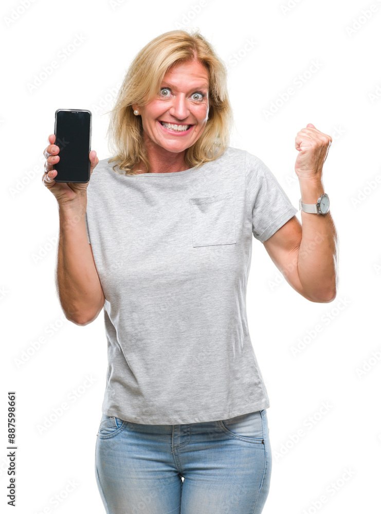 Middle age blonde woman showing blank screen of smartphone over isolated background screaming proud and celebrating victory and success very excited, cheering emotion Middle age blonde woman showing blank screen of smartphone over isolated background screaming proud and celebrating victory and success very excited, cheering emotion