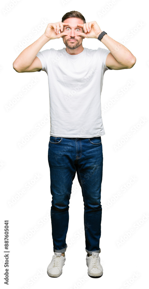 Handsome man wearing casual white t-shirt Trying to open eyes with fingers, sleepy and tired for morning fatigue Handsome man wearing casual white t-shirt Trying to open eyes with fingers, sleepy and tired for morning fatigue