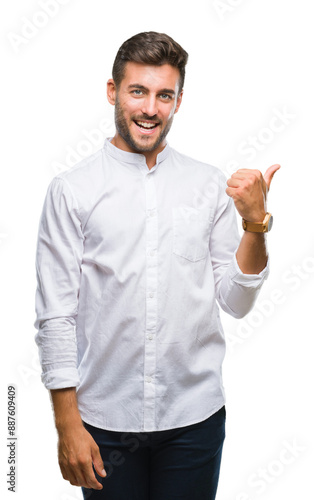 Young handsome man over isolated background smiling with happy face looking and pointing to the side with thumb up.