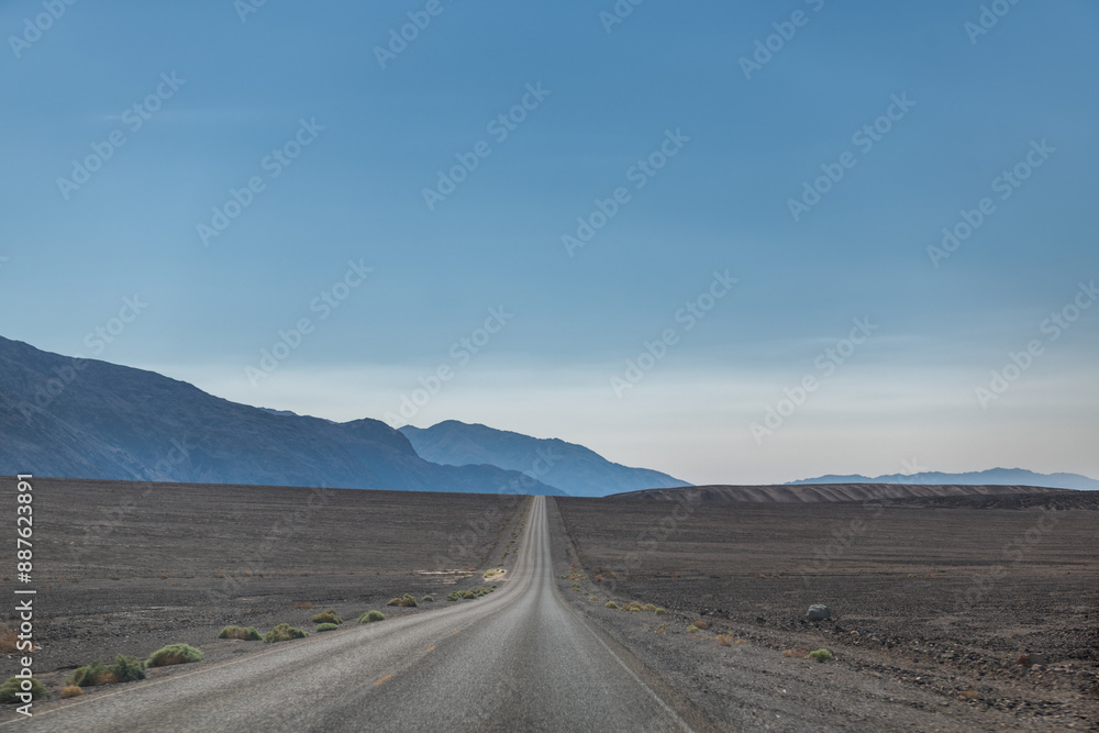 Fototapeta premium A long road stretches across a desert landscape
