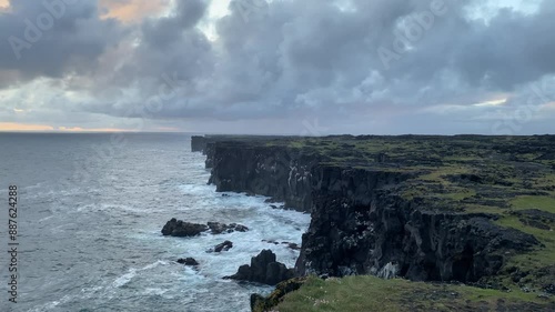 huge waves crash on the shore, Rocky ocean coast in Iceland photo