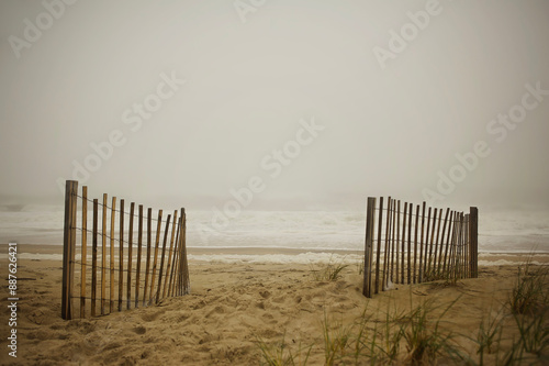 Sand dune weathered fence misty ocean Cape Hatteras