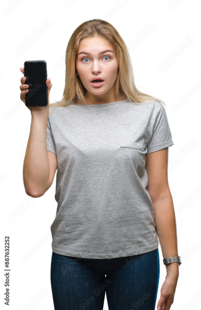 Young caucasian woman showing screen of smartphone over isolated background scared in shock with a surprise face, afraid and excited with fear expression Young caucasian woman showing screen of smartphone over isolated background scared in shock with a surprise face, afraid and excited with fear expression