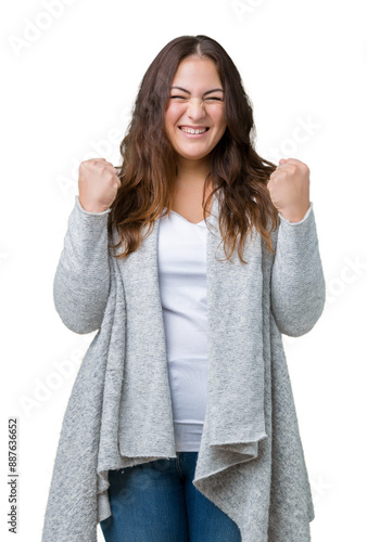 Beautiful plus size young woman wearing winter jacket over isolated background excited for success with arms raised celebrating victory smiling. Winner concept.