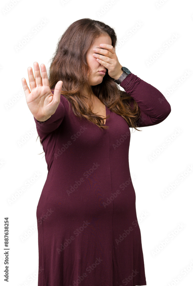 Beautiful and attractive plus size young woman wearing a dress over isolated background covering eyes with hands and doing stop gesture with sad and fear expression. Embarrassed and negative concept. Beautiful and attractive plus size young woman wearing a dress over isolated background covering eyes with hands and doing stop gesture with sad and fear expression. Embarrassed and negative concept.