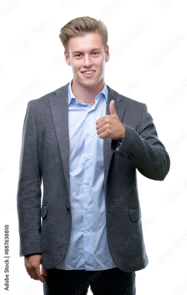 Young handsome blond business man doing happy thumbs up gesture with hand. Approving expression looking at the camera with showing success. Young handsome blond business man doing happy thumbs up gesture with hand. Approving expression looking at the camera with showing success.
