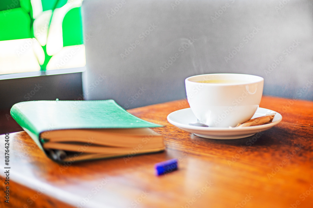 notebook with a cup of hot coffee or tea on the table. good morning. planning the day, week. Back to school notebook with a cup of hot coffee or tea on the table. good morning. planning the day, week. Back to school